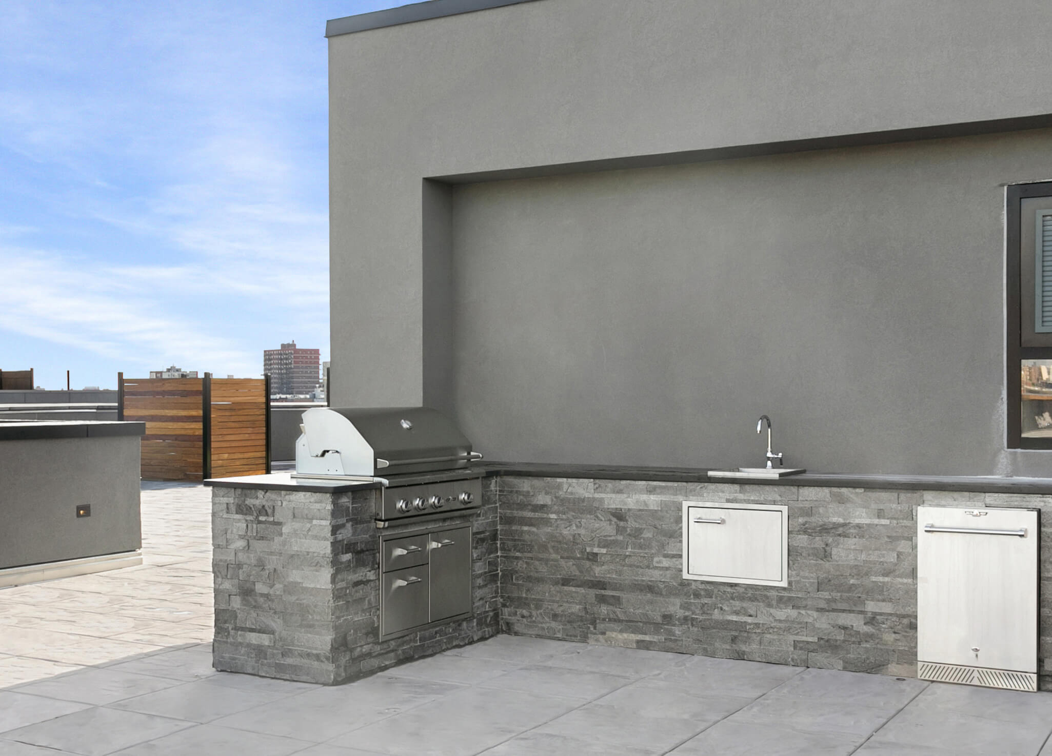 Outdoor kitchen with barbeque on 555 Waverly's roof deck